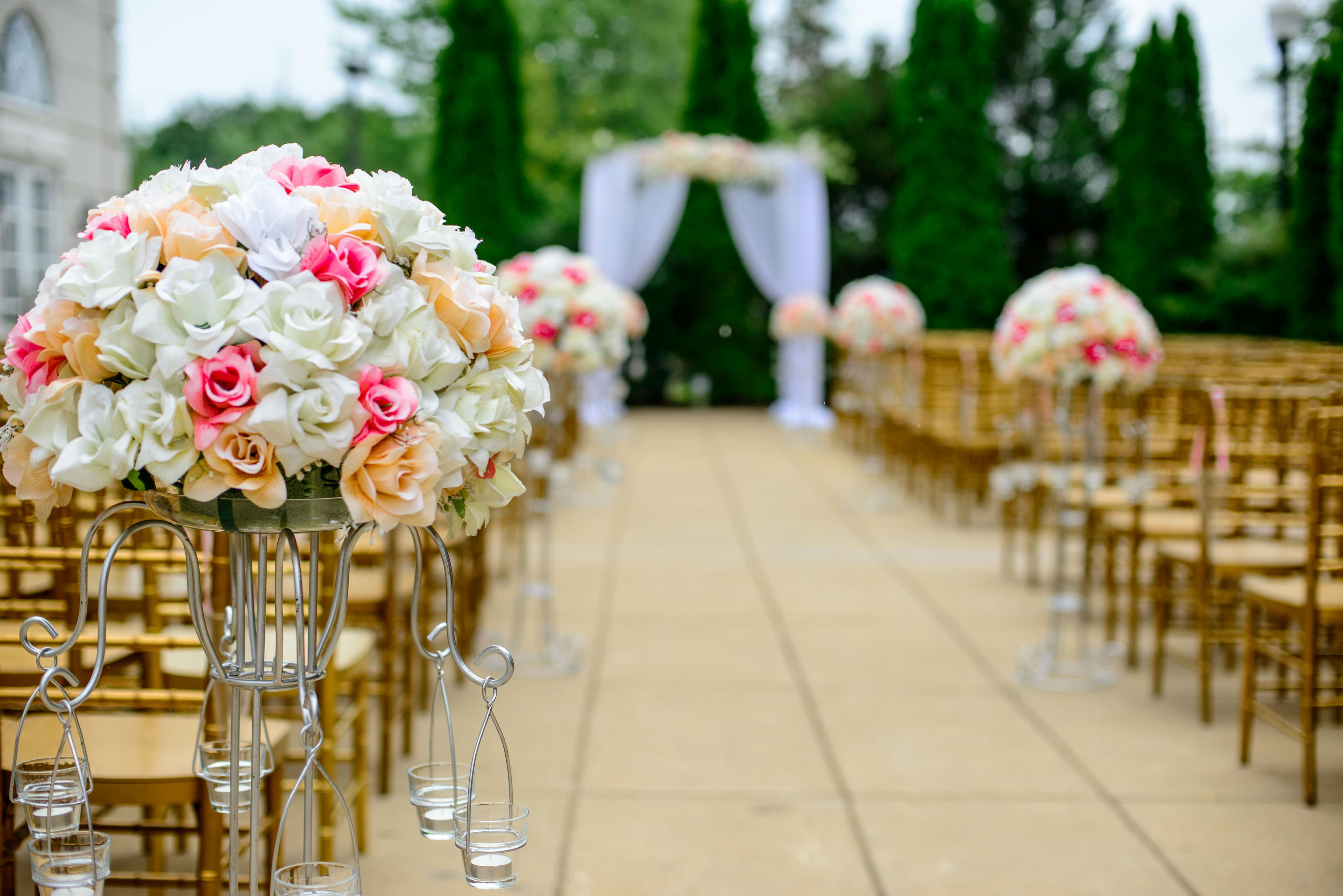 Ivory and blush floral wedding stage under a draped canopy